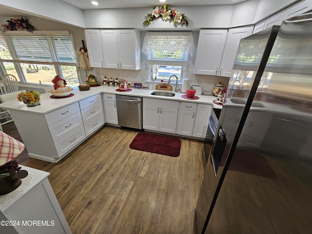 kitchen with plenty of natural light, stainless steel dishwasher, and white cabinets