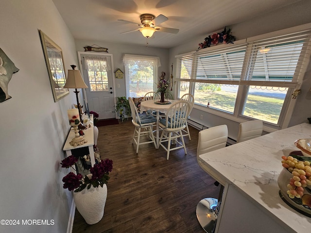 dining space with dark hardwood / wood-style flooring, a baseboard heating unit, and ceiling fan