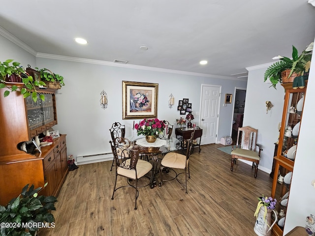 dining area with wood-type flooring, a baseboard heating unit, and ornamental molding