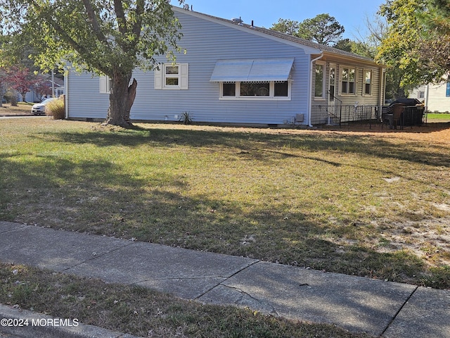 view of side of home featuring a yard