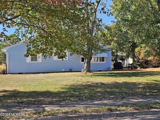 view of property exterior featuring a lawn