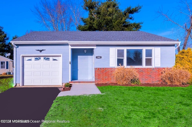 ranch-style home with a front yard and a garage