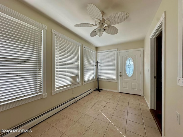 tiled foyer featuring baseboard heating and ceiling fan