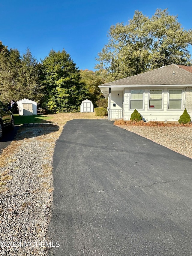 view of side of property with a storage shed