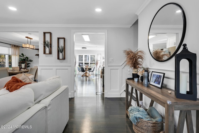 living room with crown molding and dark wood-type flooring