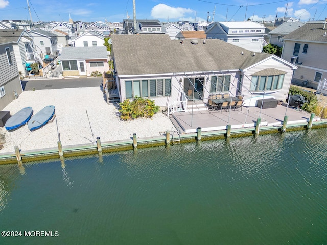 back of house with a patio and a water view