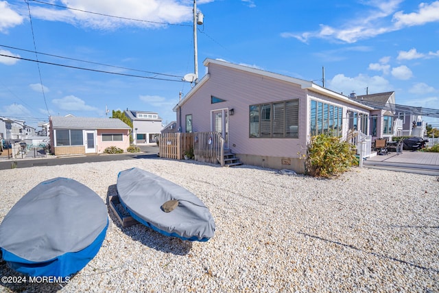 rear view of property featuring a wooden deck