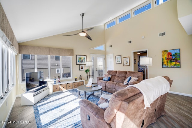 living room with high vaulted ceiling, wood-type flooring, a healthy amount of sunlight, and ceiling fan