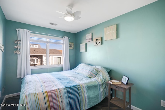 bedroom with ceiling fan and dark hardwood / wood-style flooring