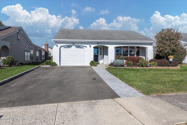 view of front of house with a front yard and a garage