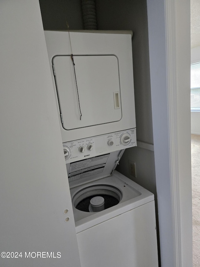 laundry area featuring stacked washer / dryer