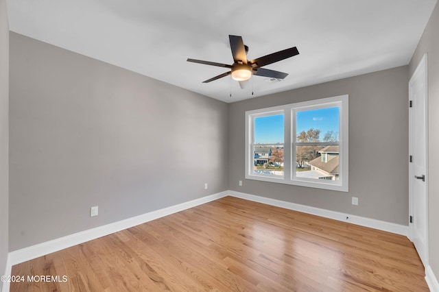 spare room featuring light hardwood / wood-style flooring and ceiling fan