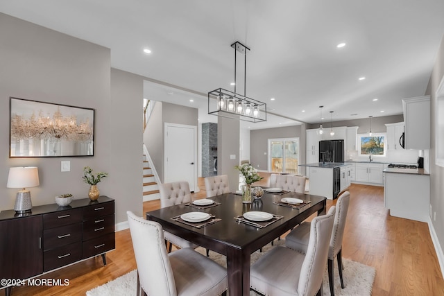 dining area with light wood-type flooring and sink