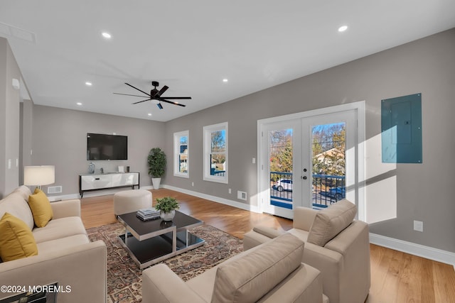 living room featuring electric panel, ceiling fan, french doors, and wood-type flooring