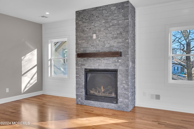 unfurnished living room featuring a fireplace and hardwood / wood-style flooring