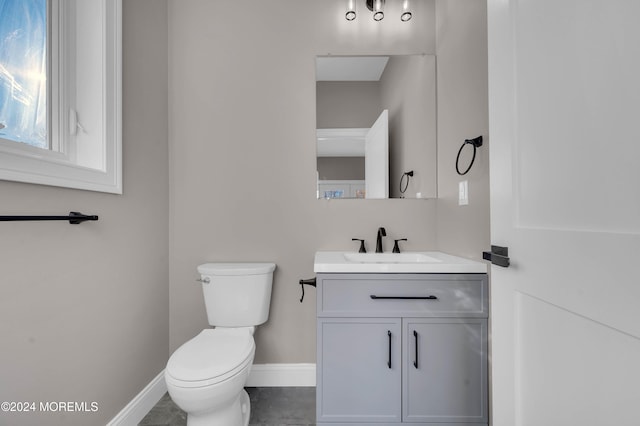 bathroom with tile patterned flooring, vanity, and toilet