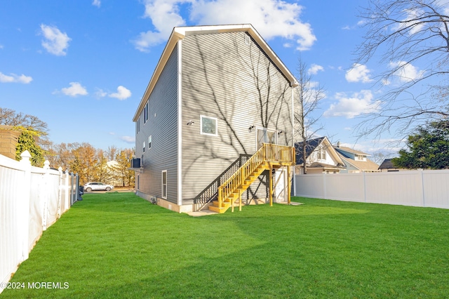 rear view of property with a lawn