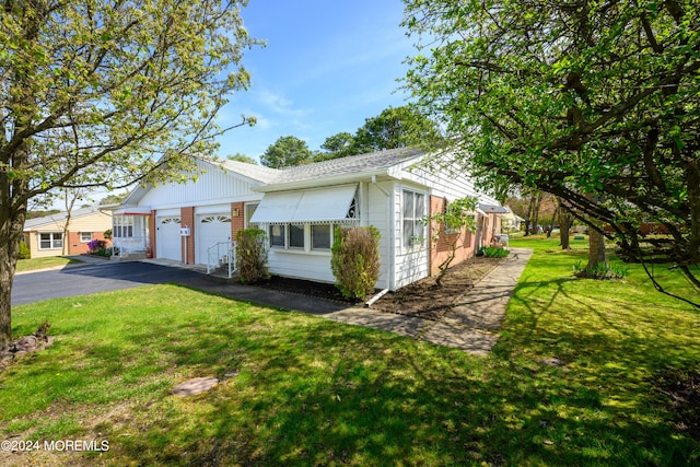 view of front of home with a front lawn and a garage