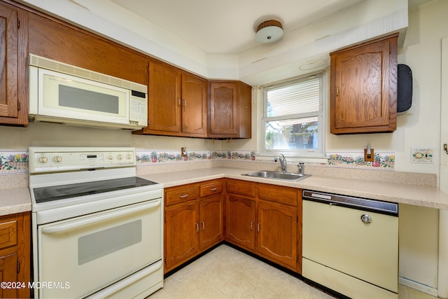 kitchen featuring white appliances and sink