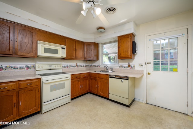 kitchen featuring sink, white appliances, and ceiling fan