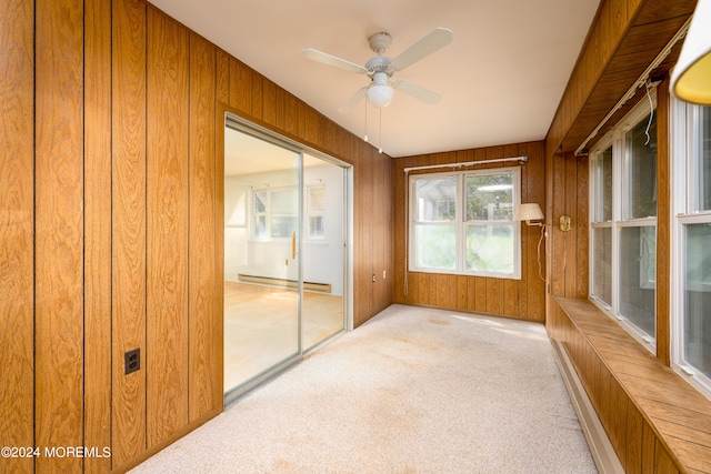 unfurnished sunroom featuring ceiling fan and a baseboard radiator