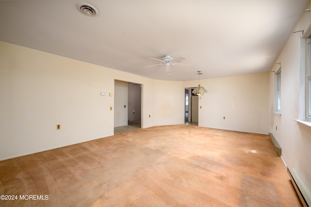 empty room featuring light carpet, a baseboard heating unit, and ceiling fan