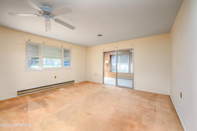 empty room featuring light carpet, a baseboard radiator, and ceiling fan