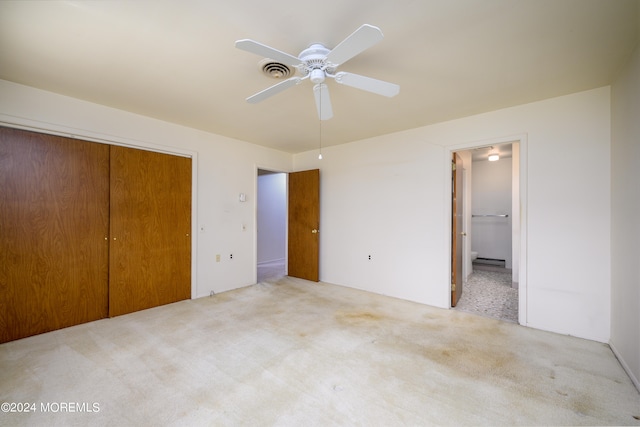 unfurnished bedroom with a closet, ceiling fan, and light colored carpet