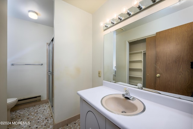 bathroom with vanity, tile patterned flooring, toilet, a baseboard heating unit, and a shower stall