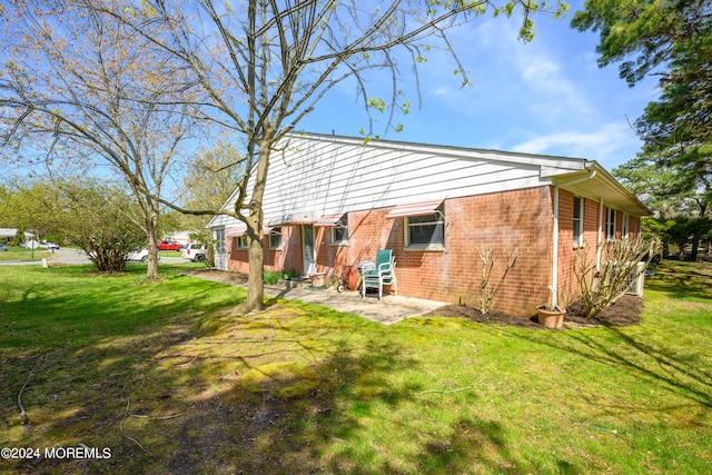 back of house featuring a patio and a lawn