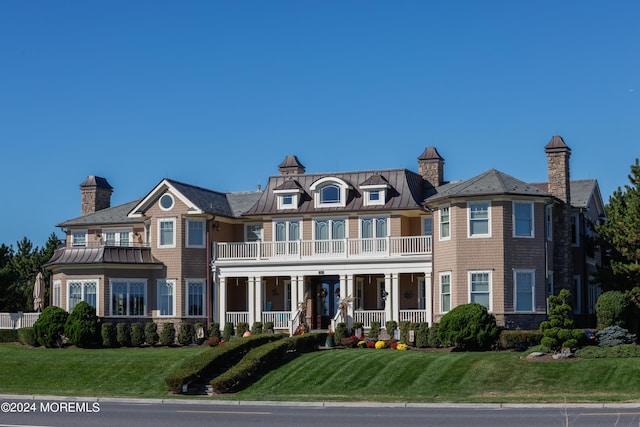 1805 Ocean Ave, Spring Lake, NJ 07762 - view of front facade featuring a standing seam roof, covered porch, and metal roof