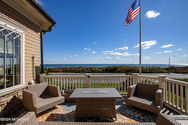 wooden terrace featuring a water view