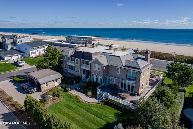 birds eye view of property with a view of the beach and a water view