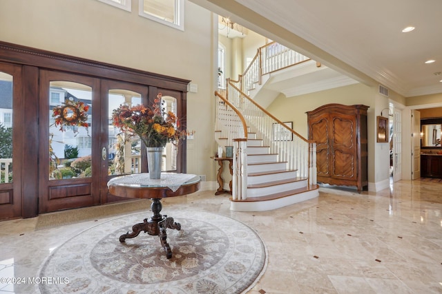 entrance foyer with ornamental molding and french doors