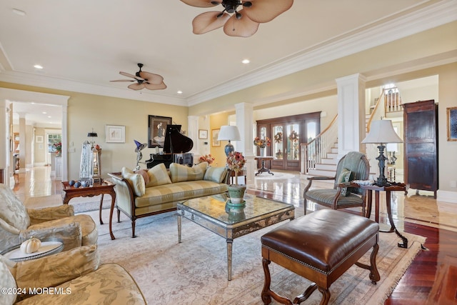 living room with ceiling fan, ornate columns, and light wood-type flooring