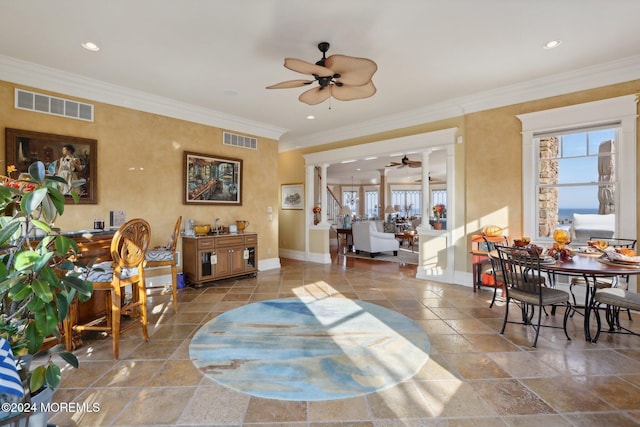 interior space featuring ornamental molding, decorative columns, and plenty of natural light