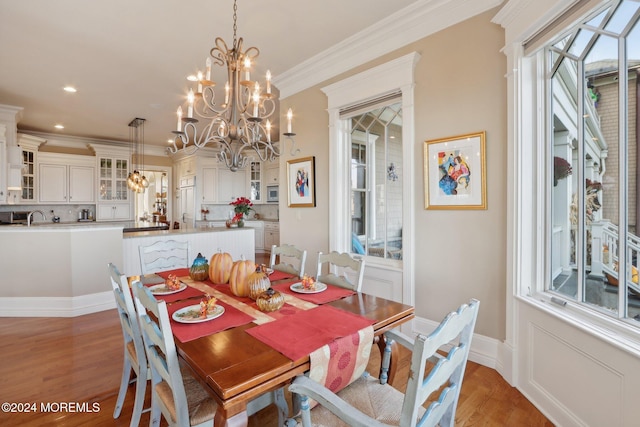 dining room featuring sink, crown molding, dark hardwood / wood-style floors, and an inviting chandelier