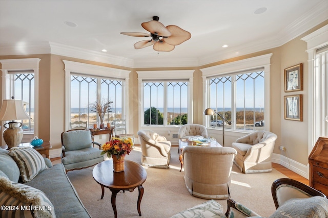 living room with ceiling fan and ornamental molding