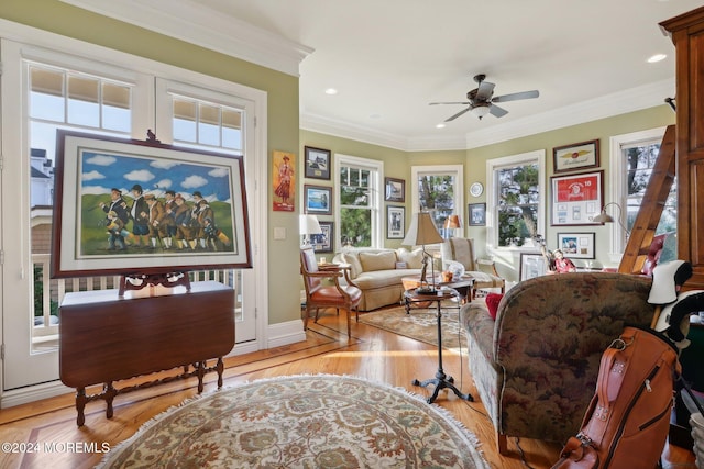 sitting room featuring light hardwood / wood-style floors, crown molding, and ceiling fan