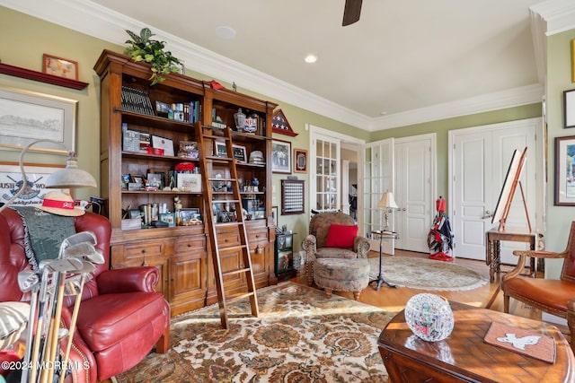 sitting room with ornamental molding, hardwood / wood-style floors, and ceiling fan