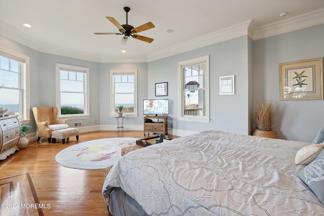 bedroom featuring multiple windows, light wood-type flooring, and ceiling fan