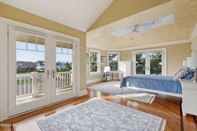 bedroom featuring access to outside, french doors, multiple windows, and light hardwood / wood-style floors