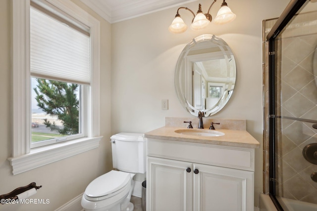 bathroom with a shower with door, vanity, crown molding, and toilet