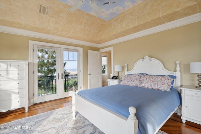 bedroom featuring access to outside, french doors, wood-type flooring, and ceiling fan