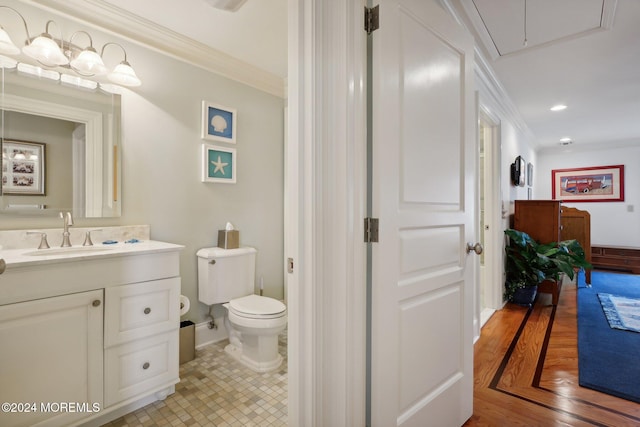 bathroom featuring vanity, crown molding, hardwood / wood-style flooring, and toilet