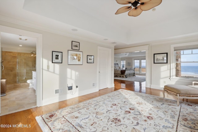 interior space with ornamental molding, hardwood / wood-style flooring, and ceiling fan