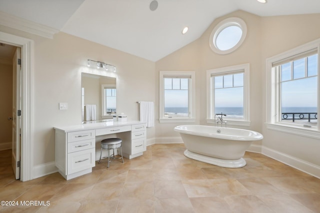 bathroom with a bath, lofted ceiling, tile patterned flooring, and vanity