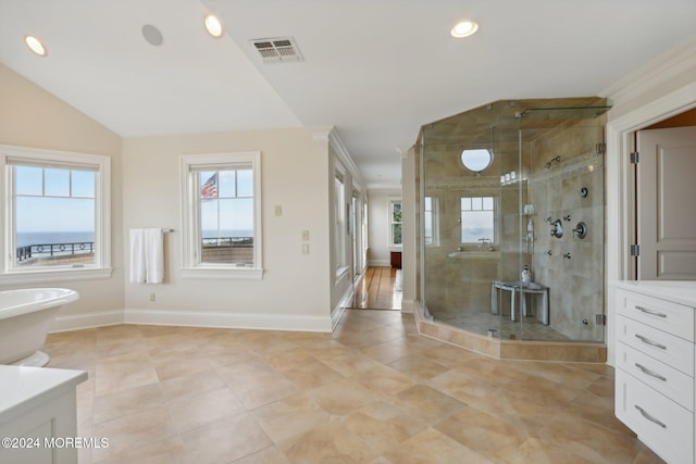 bathroom with tile patterned floors, ornamental molding, vaulted ceiling, vanity, and shower with separate bathtub