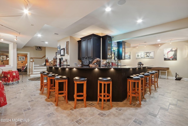 1805 Ocean Ave, Spring Lake, NJ 07762 - kitchen featuring stone tile flooring, a breakfast bar, a peninsula, track lighting, and recessed lighting
