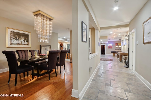 1805 Ocean Ave, Spring Lake, NJ 07762 - dining room featuring baseboards, a chandelier, and stone tile floors
